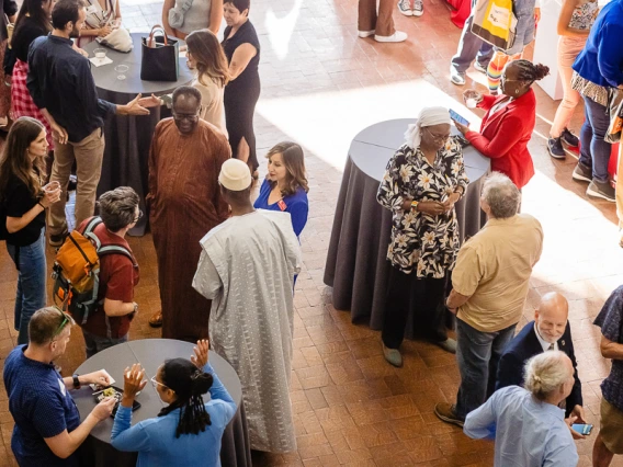 Speaker interacting with attendees during keynote reception