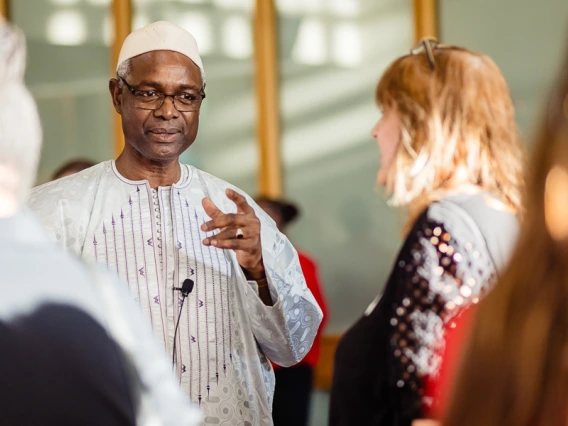 Speaker interacting with attendees during keynote reception