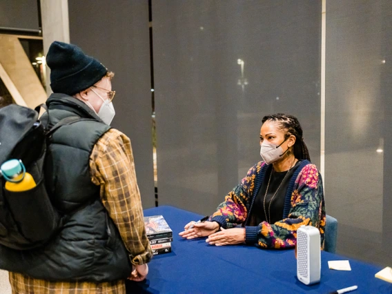 Speaker with attendee during book signing