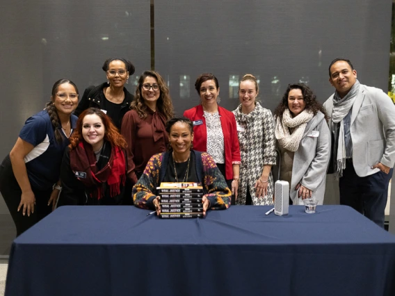 Speaker with volunteer group during book signing