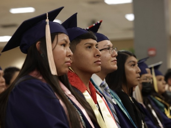 students wearing graduation caps and gowns