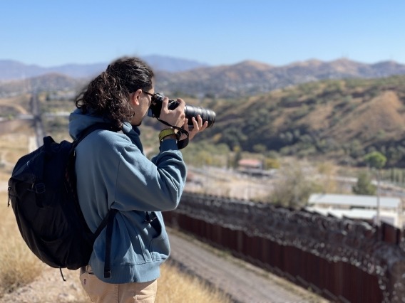 student taking photos of the border