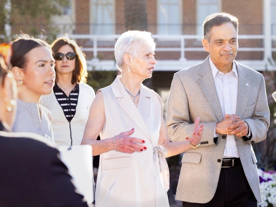 Pat Gerleman standing and speaking next to Suresh Garimella.