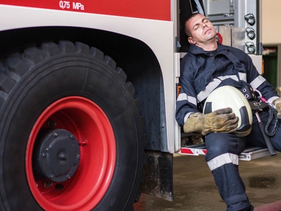 a firefighter taking a nap in a truck