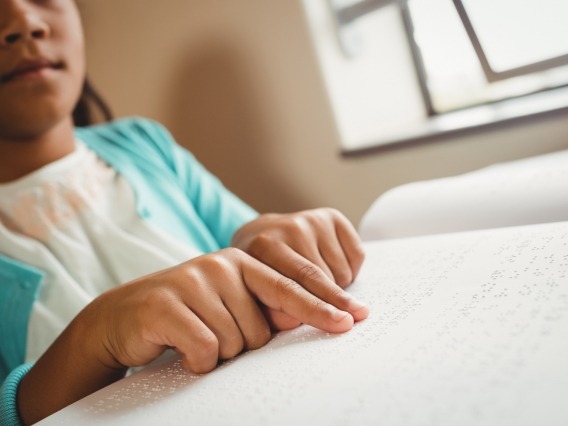 a child reading with Braille