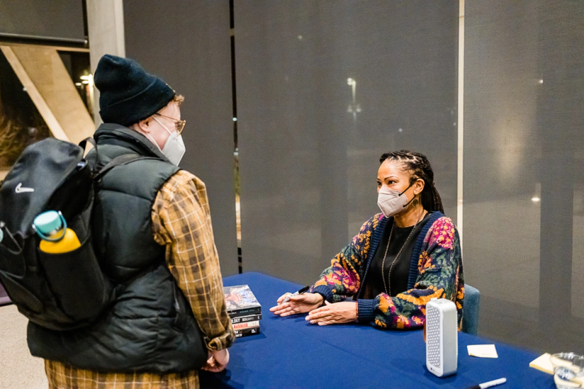 Speaker with attendee during book signing