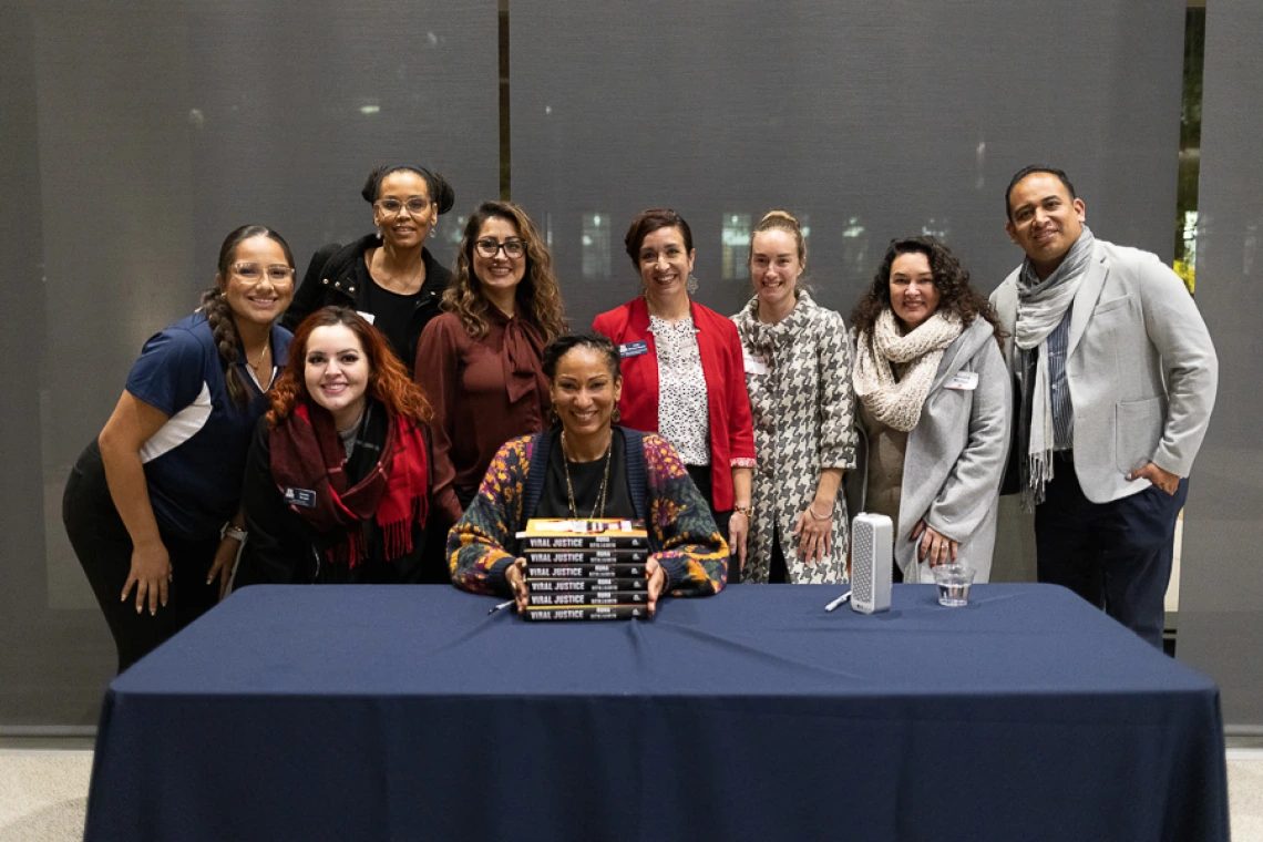 Speaker with volunteer group during book signing