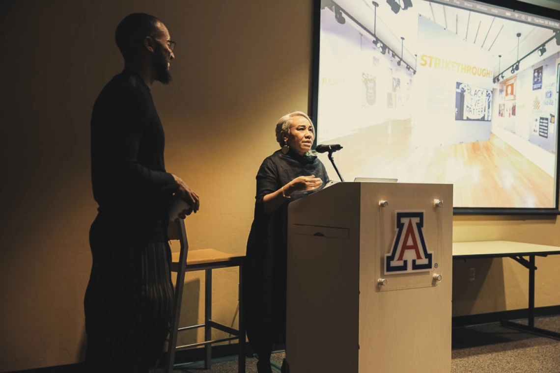 Gloria at podium with Silas